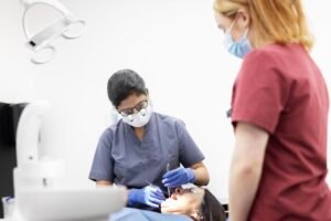 Hygienist performing dental hygiene treatment on a patient