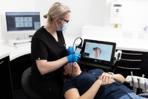 Orthodontist observing patient's teeth